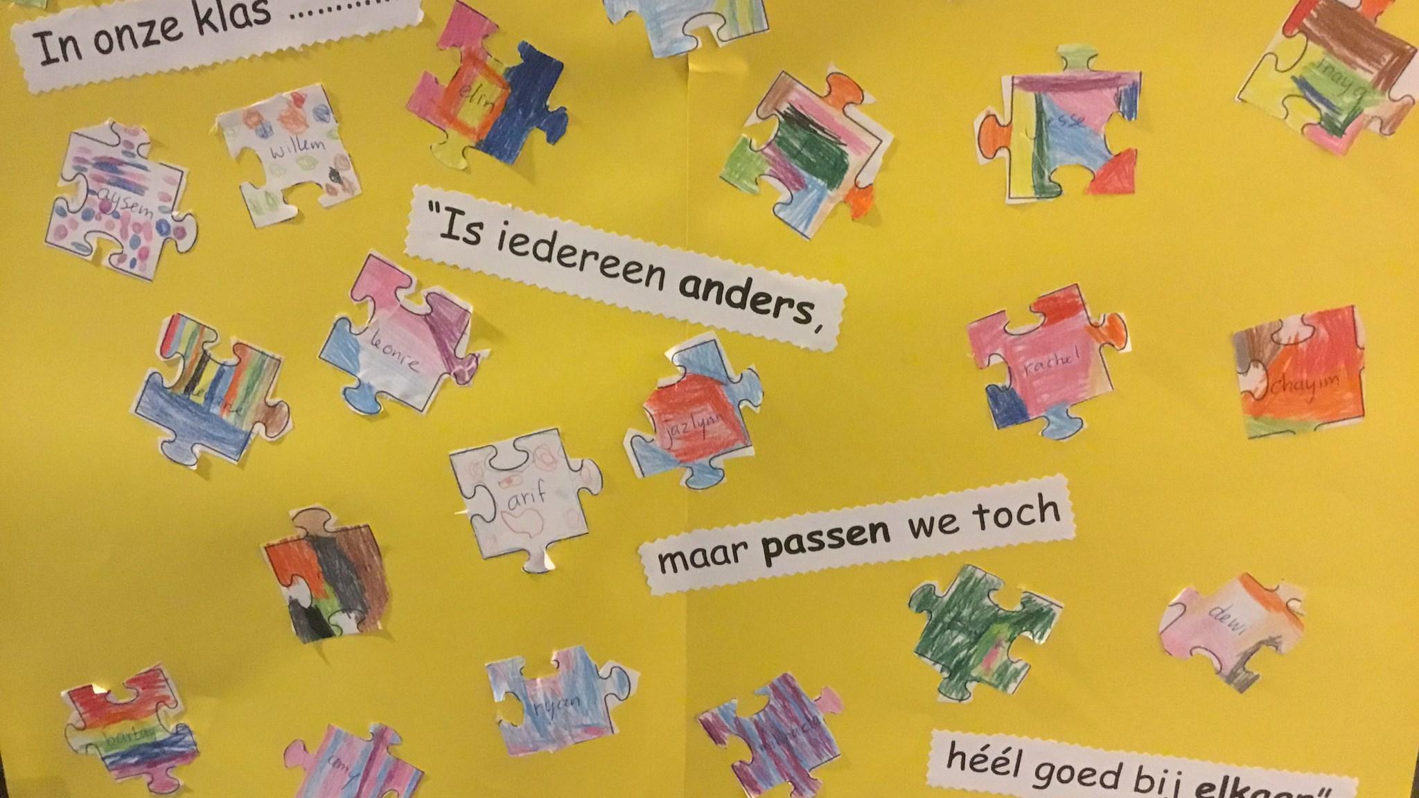 Afbeelding van een kleurrijke puzzelopstelling met namen van leerlingen in de klas van Basisschool Menkotoren in Enschede, benadrukkend dat "iedereen anders is, maar we toch héél goed bij elkaar passen". Afbeelding van een kleurrijke puzzelopstelling met namen van leerlingen in de klas van Basisschool Menkotoren in Enschede, benadrukkend dat "iedereen anders is, maar we toch héél goed bij elkaar passen".