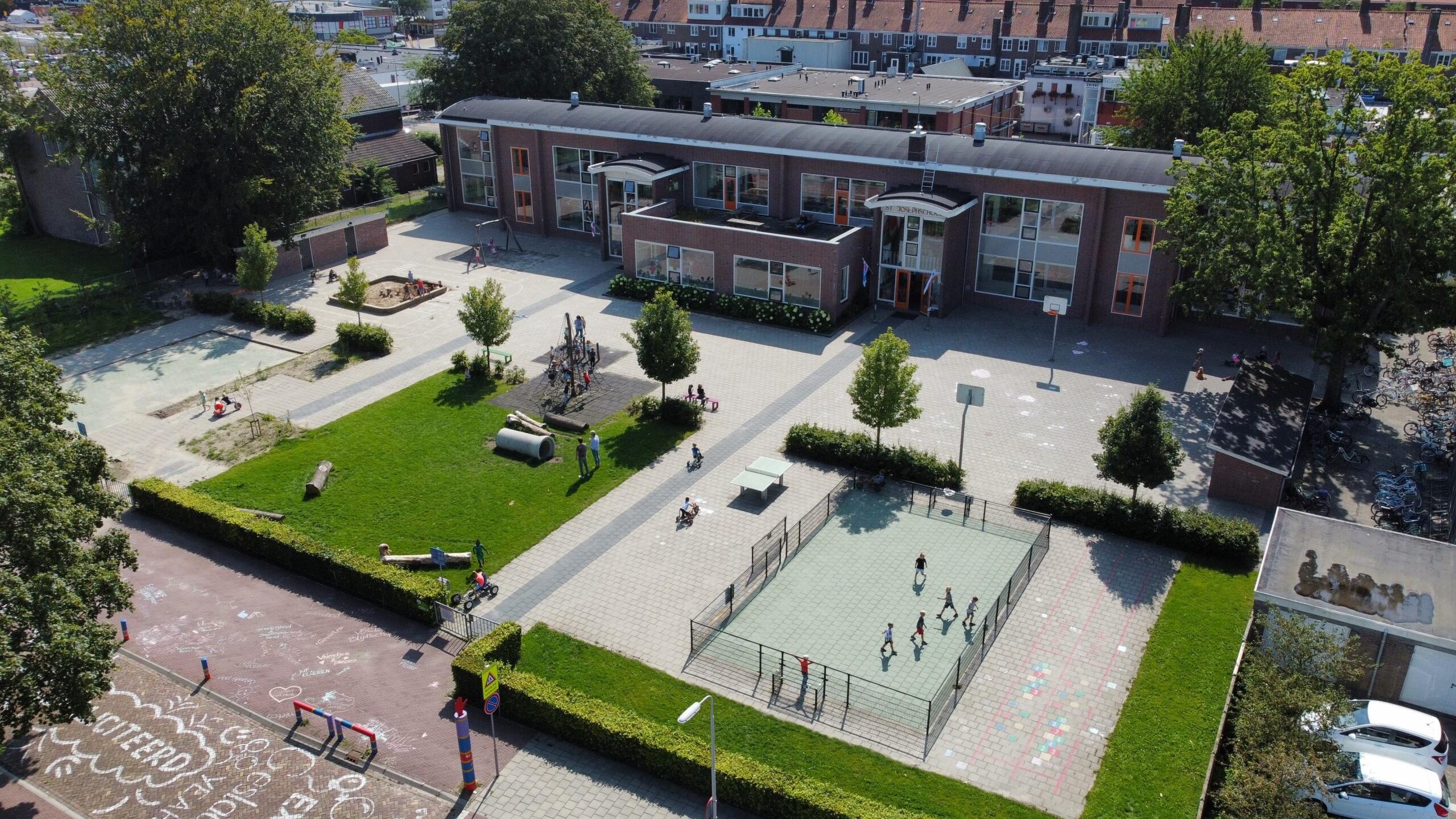 Afbeelding van het schoolplein van Kindcentrum St. Joseph in Emmeloord met kinderen die spelen. Afbeelding van het schoolplein van Kindcentrum St. Joseph in Emmeloord met kinderen die spelen.