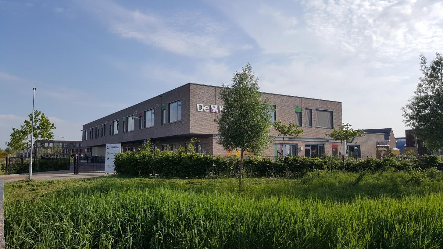 Basisschool De Wingerd in Goes, met een modern gebouw omringd door groen. Basisschool De Wingerd in Goes, met een modern gebouw omringd door groen.