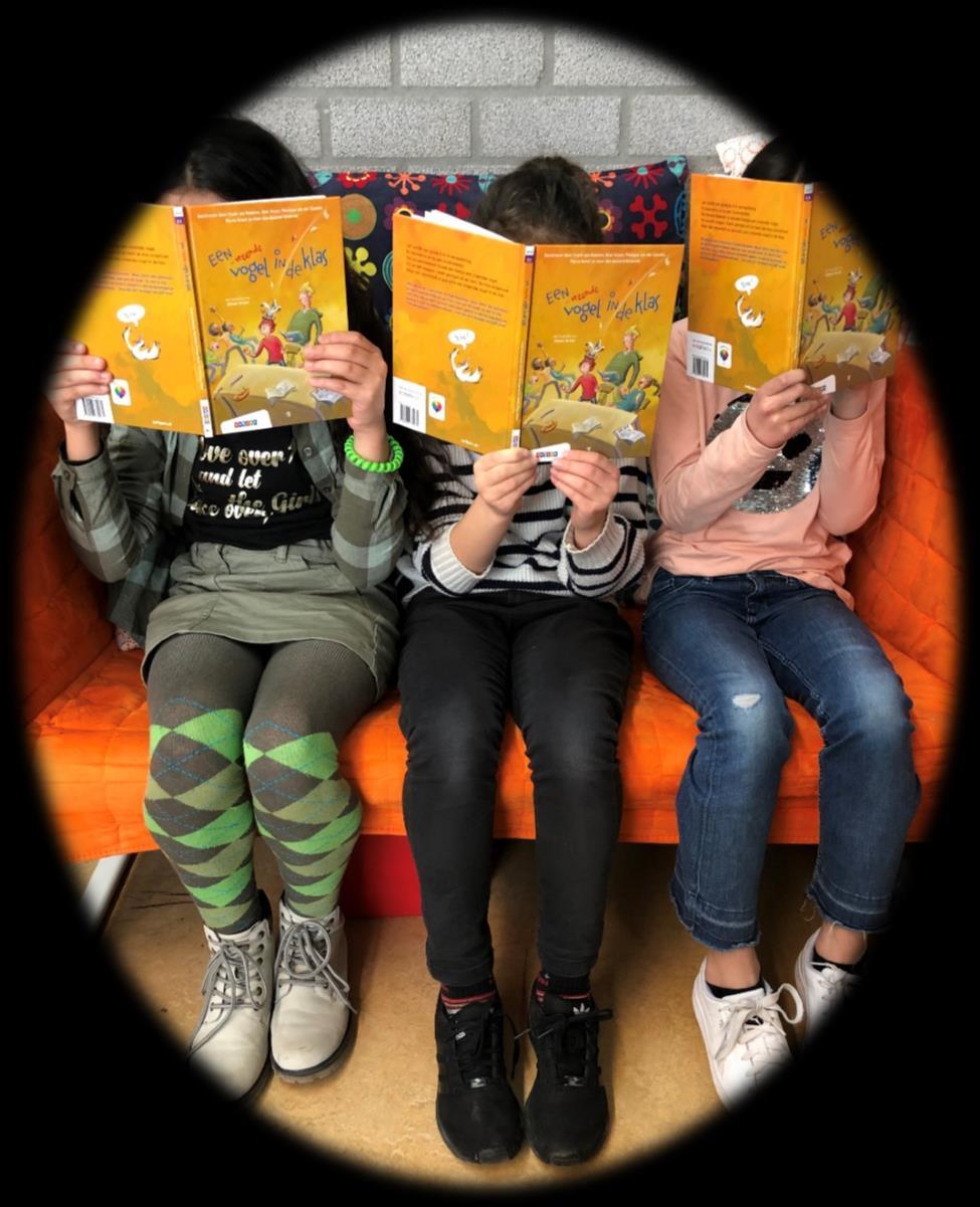 Drie kinderen lezen een boek op een bank in Basisschool De Regenboog in Cuijk. Drie kinderen lezen een boek op een bank in Basisschool De Regenboog in Cuijk.