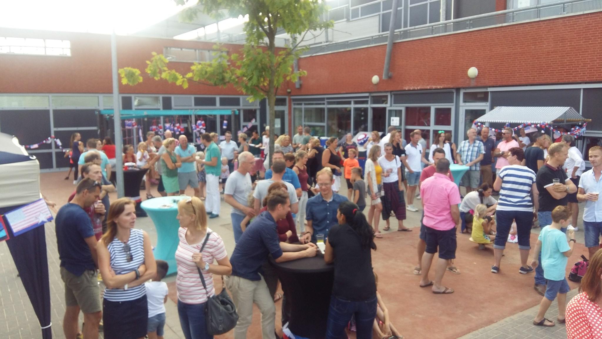 Een drukke bijeenkomst op het schoolplein van De Brug in Aalsmeer.