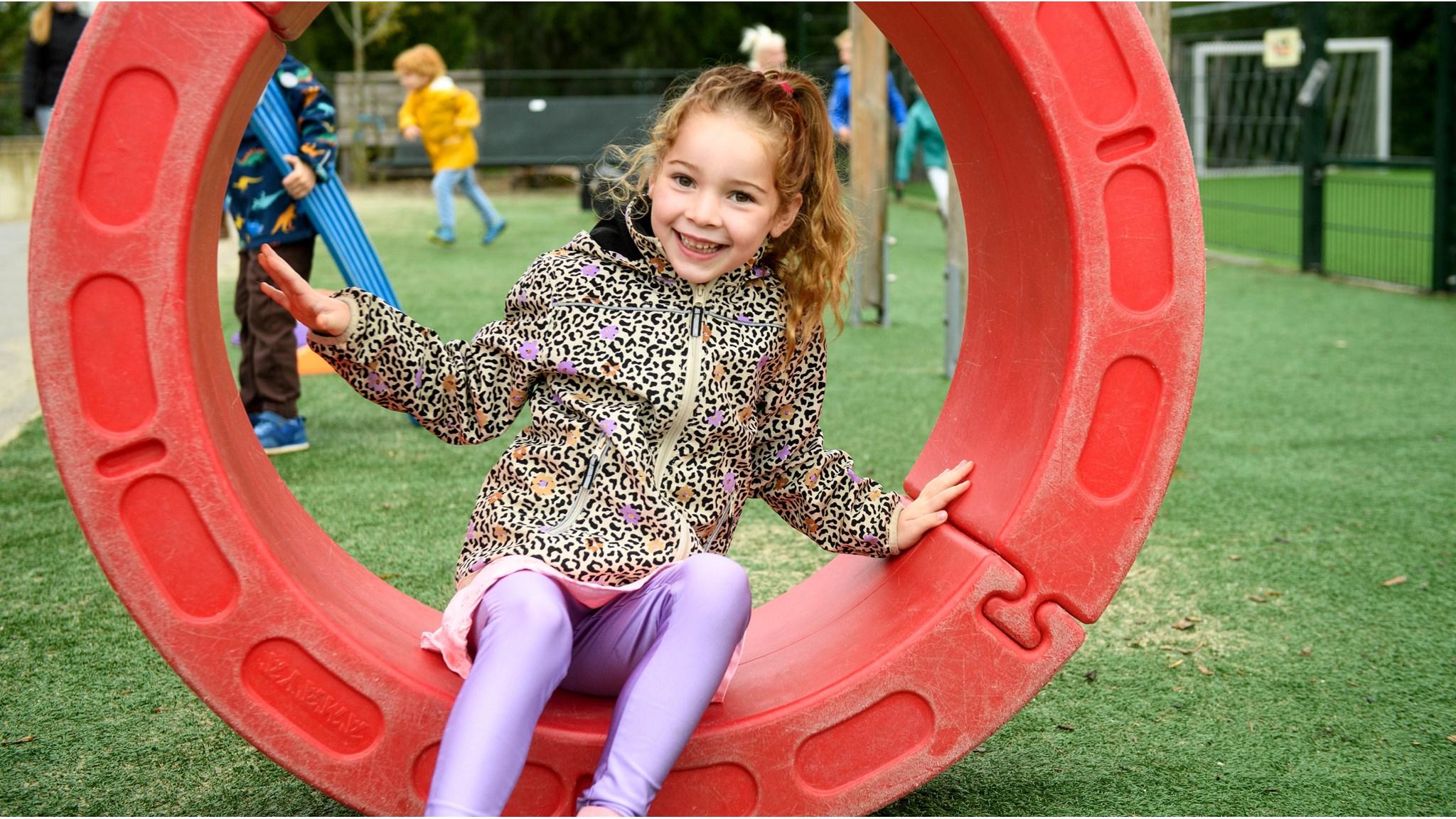 Een glimlachend meisje speelt op het schoolplein van RKBS St. Jozef in Zwaagdijk-Oost. Een glimlachend meisje speelt op het schoolplein van RKBS St. Jozef in Zwaagdijk-Oost.
