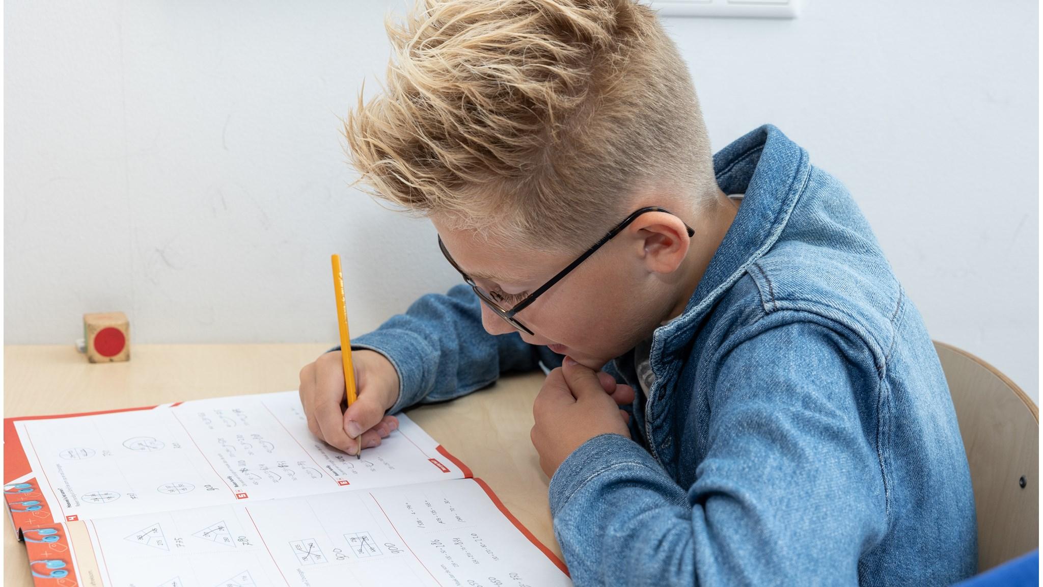 Een jongen is aan het leren met zijn werkboek op Openbare Basisschool De Twa Fisken in Grou. Een jongen is aan het leren met zijn werkboek op Openbare Basisschool De Twa Fisken in Grou.