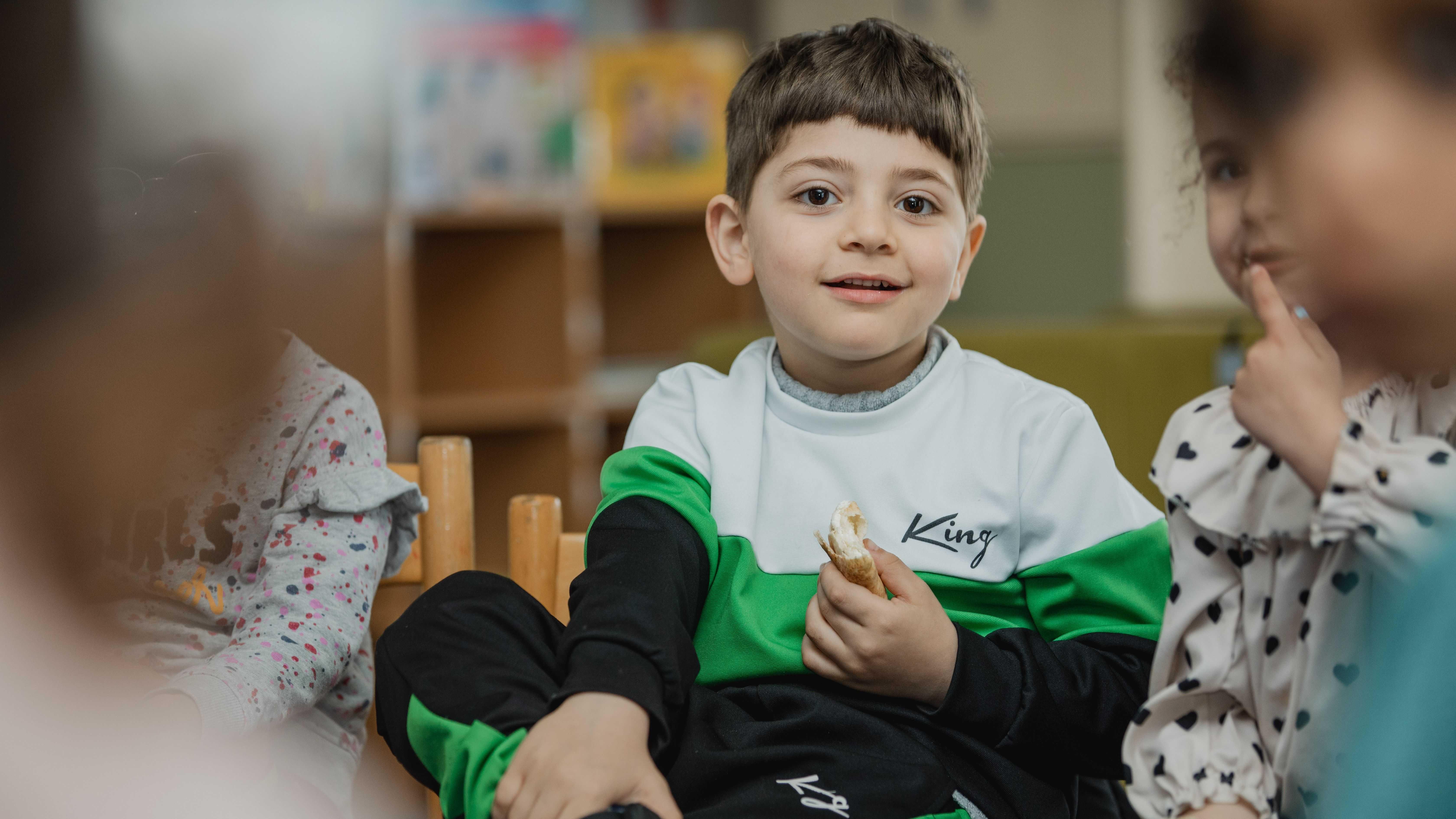Een jongen met een snack geniet van het moment in de klas van Openbare Basisschool Emmermeer in Emmen. Een jongen met een snack geniet van het moment in de klas van Openbare Basisschool Emmermeer in Emmen.