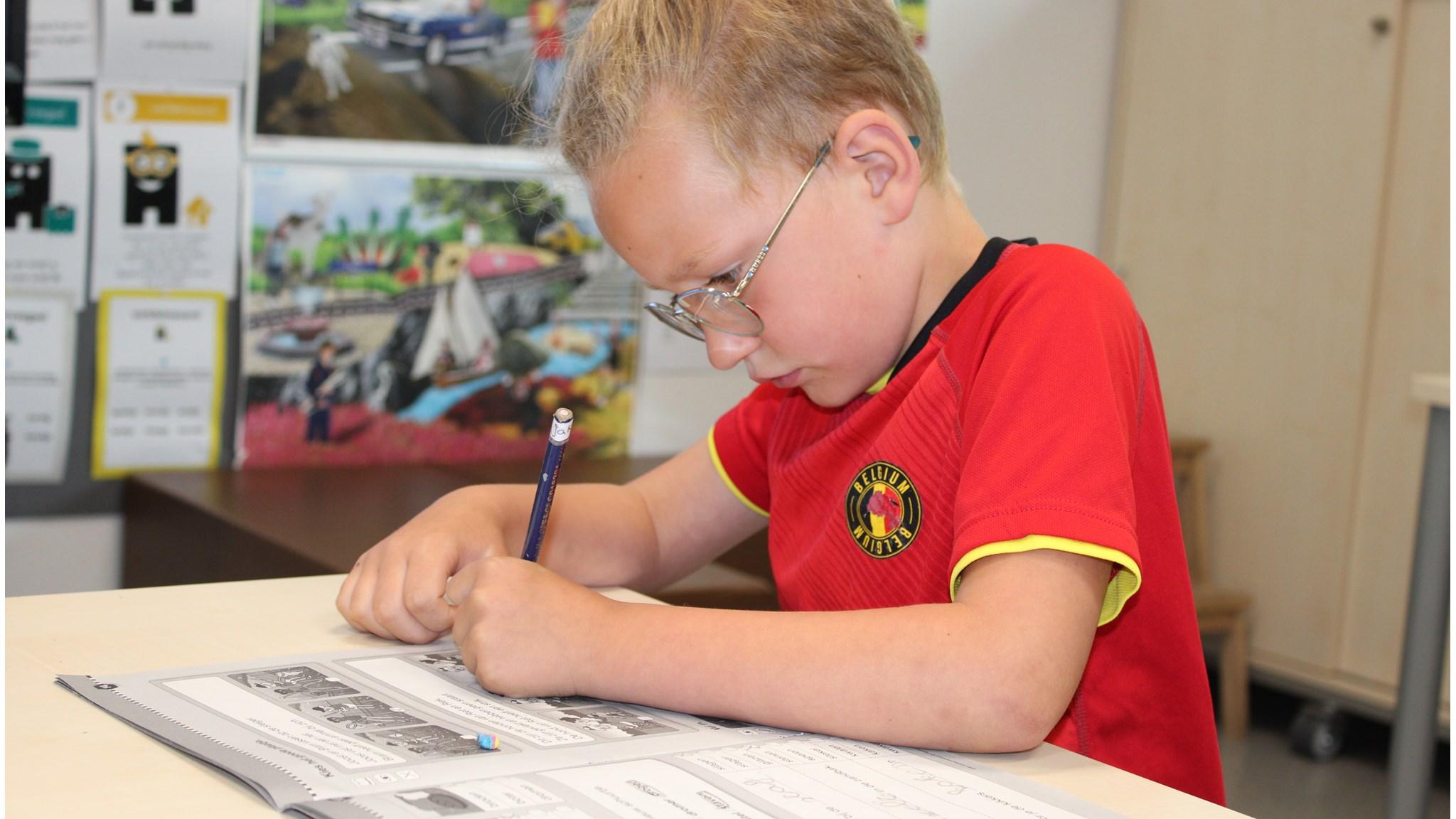 Een jongen van Openbare Basisschool de Kraaienboom in Benningbroek is bezig met zijn huiswerk. Een jongen van Openbare Basisschool de Kraaienboom in Benningbroek is bezig met zijn huiswerk.