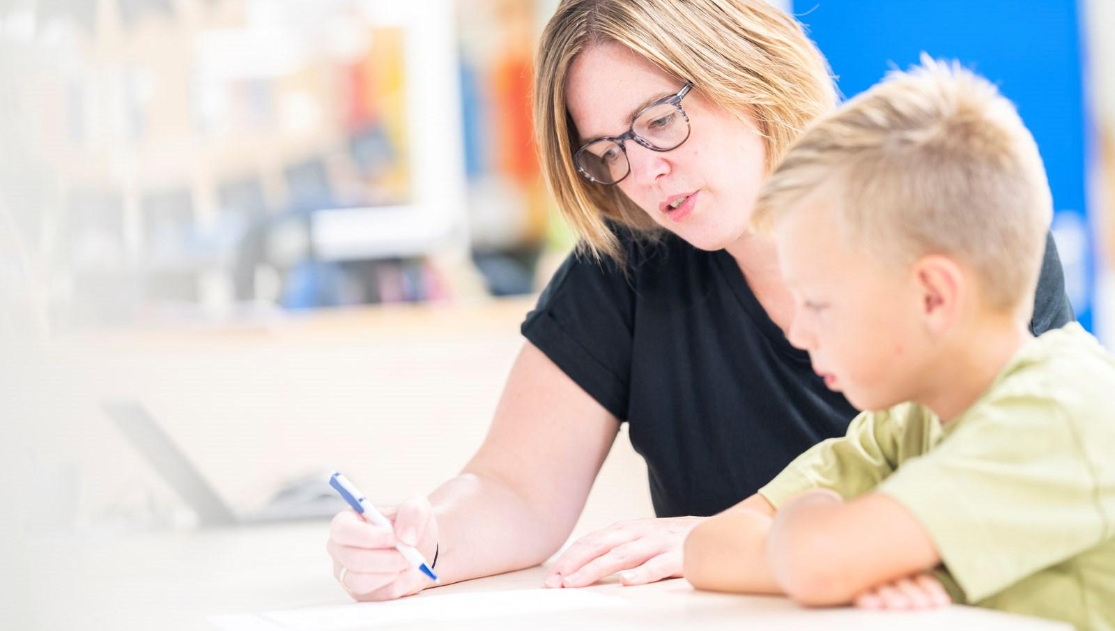 Een leerkracht helpt een leerling met zijn werk op basisschool Het Zuiderlicht in Dronten. Een leerkracht helpt een leerling met zijn werk op basisschool Het Zuiderlicht in Dronten.