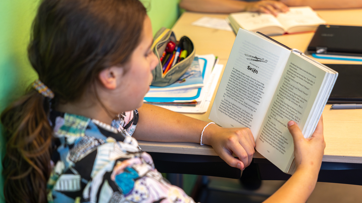 Een leerling leest een boek in de klas van Openbare Basisschool Syncope in Almere. Een leerling leest een boek in de klas van Openbare Basisschool Syncope in Almere.