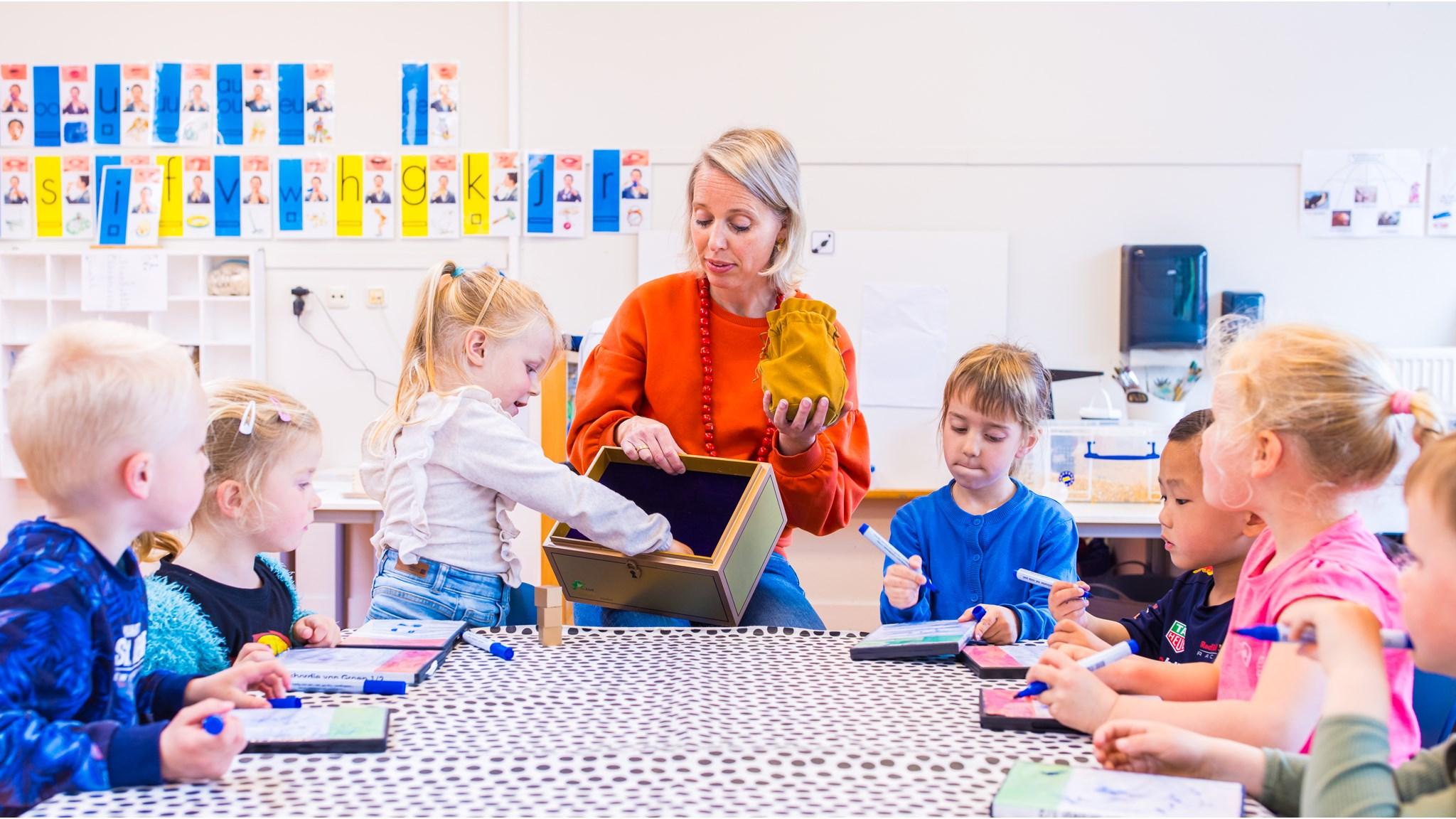 Een lerares van cbs Jan Kuipers in Grootegast begeleidt kinderen tijdens een creatieve activiteit in de klas. Een lerares van cbs Jan Kuipers in Grootegast begeleidt kinderen tijdens een creatieve activiteit in de klas.