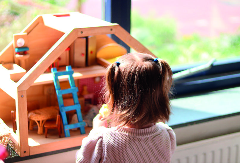 Een meisje speelt met een houten poppenhuis in obs Galvani in Den Haag. Een meisje speelt met een houten poppenhuis in obs Galvani in Den Haag.