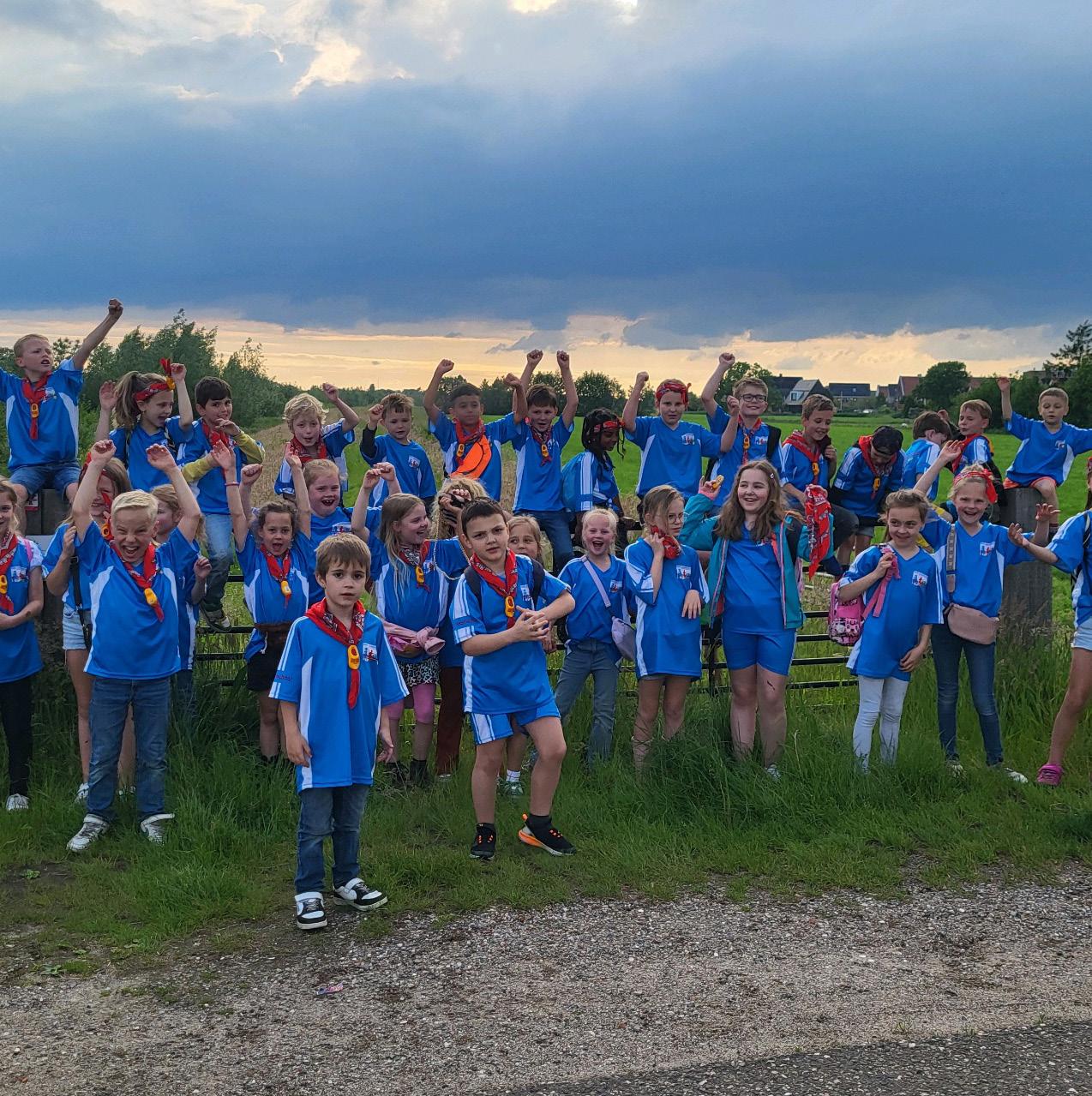 Groep blije kinderen in blauw tenue met sjaals op het schoolplein van de St. Jozefschool in Achterveld (Utrecht). Groep blije kinderen in blauw tenue met sjaals op het schoolplein van de St. Jozefschool in Achterveld (Utrecht).