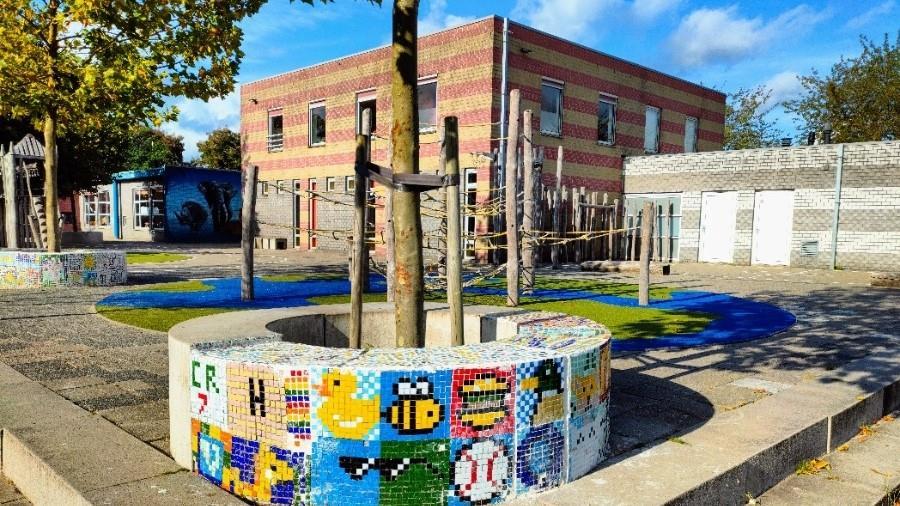 Het schoolplein van obs de Dubbelster in Amersfoort met kleurrijke mozaïeken en speeltoestellen. Het schoolplein van obs de Dubbelster in Amersfoort met kleurrijke mozaïeken en speeltoestellen.