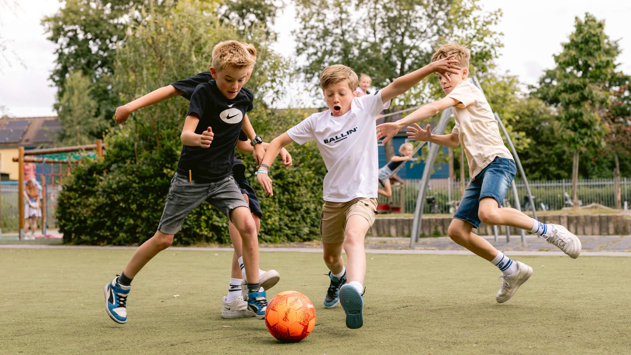 Kindcentrum De Helmstok in Lelystad, waar kinderen enthousiast voetballen op het schoolplein. Kindcentrum De Helmstok in Lelystad, waar kinderen enthousiast voetballen op het schoolplein.