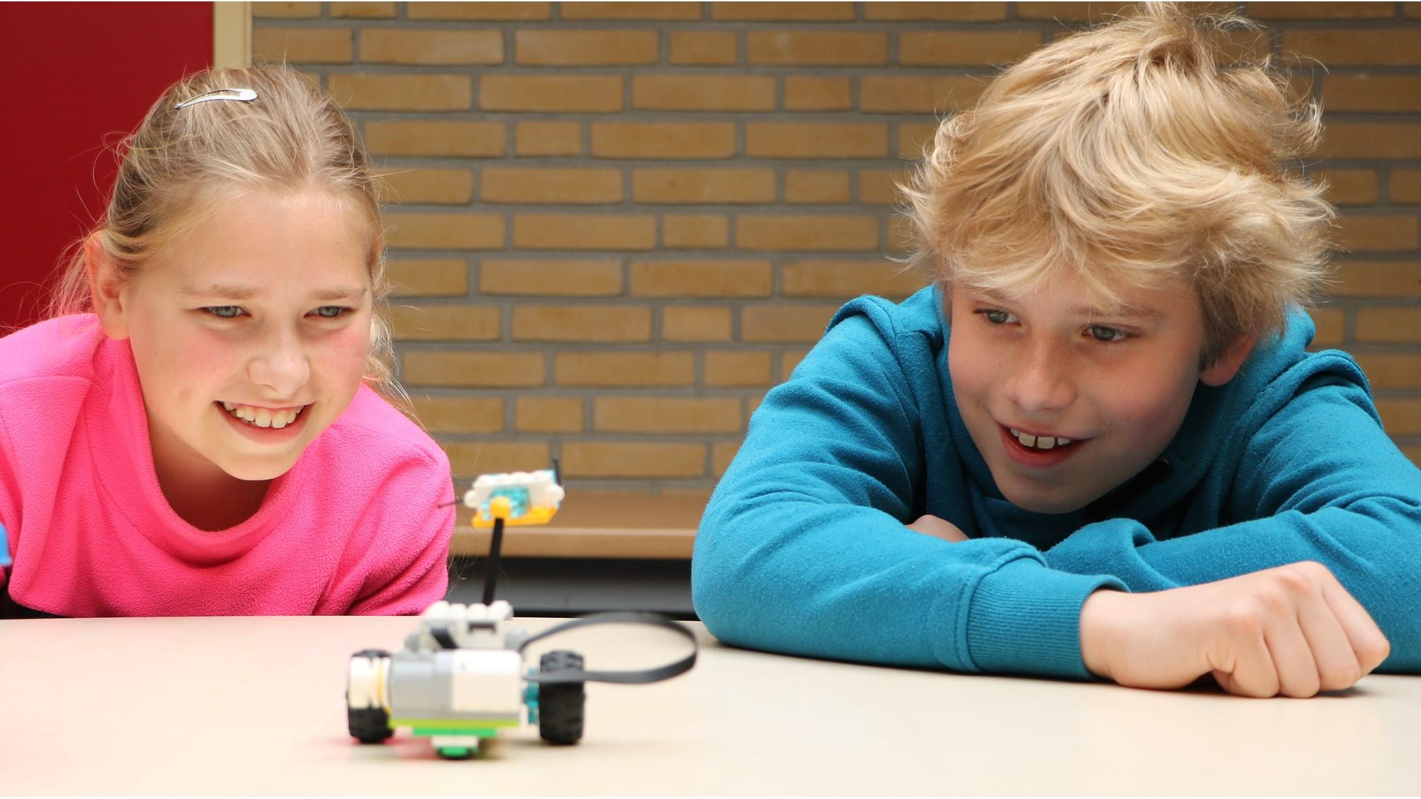 Kindcentrum De Koningsberger in Bergentheim toont kinderen die enthousiast spelen met een LEGO-robot op het schoolplein. Kindcentrum De Koningsberger in Bergentheim toont kinderen die enthousiast spelen met een LEGO-robot op het schoolplein.