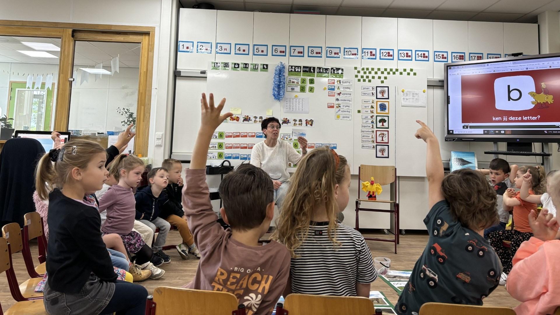 Kinderen in de klas van Basisschool Witheim in Mechelen stellen hun handen op om deel te nemen aan de les. Kinderen in de klas van Basisschool Witheim in Mechelen stellen hun handen op om deel te nemen aan de les.