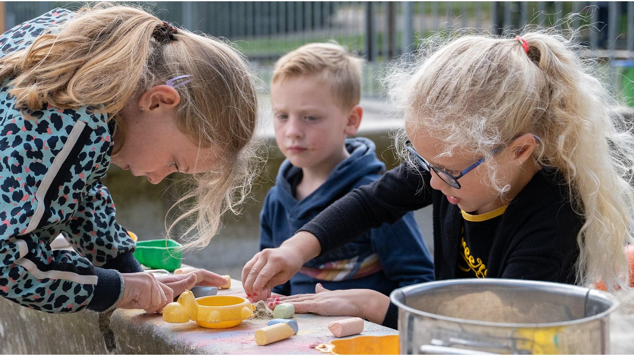 Kinderen spelen creatief met klei en materialen op het schoolplein van de Mariaschool in Beuningen (Overijssel). Kinderen spelen creatief met klei en materialen op het schoolplein van de Mariaschool in Beuningen (Overijssel).