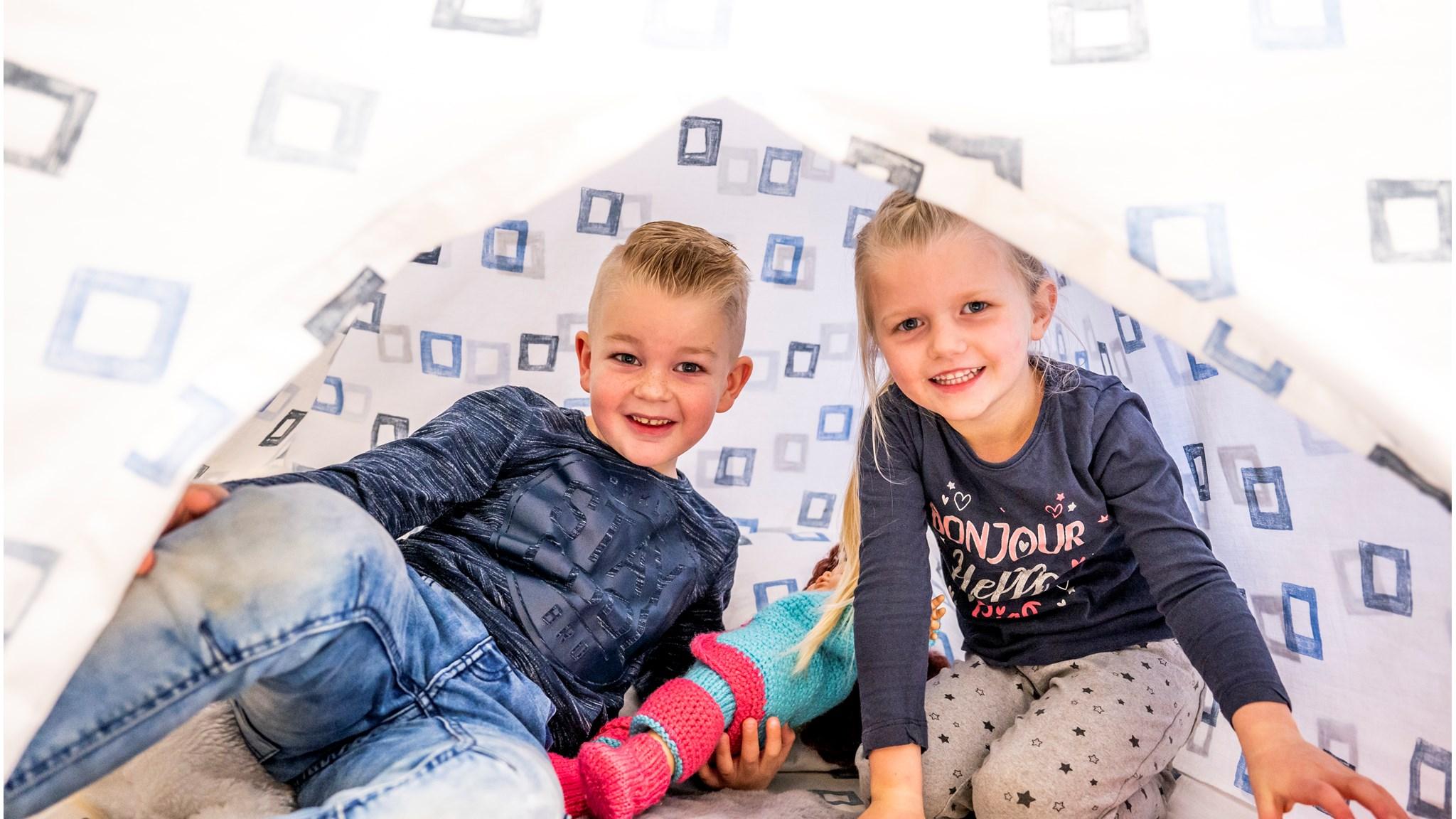 Kinderen spelen samen in een tent op het schoolplein van Openbare Basisschool De Westhoek in 2e Exloërmond.