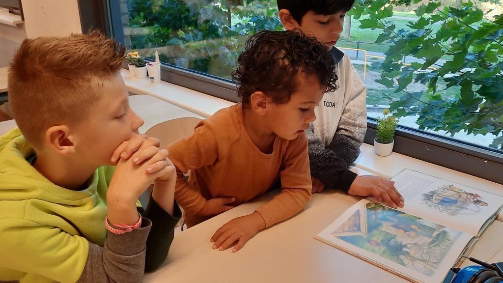 Kinderen van BS Het Klinket in Arnhem lezen samen aan een tafel. Kinderen van BS Het Klinket in Arnhem lezen samen aan een tafel.