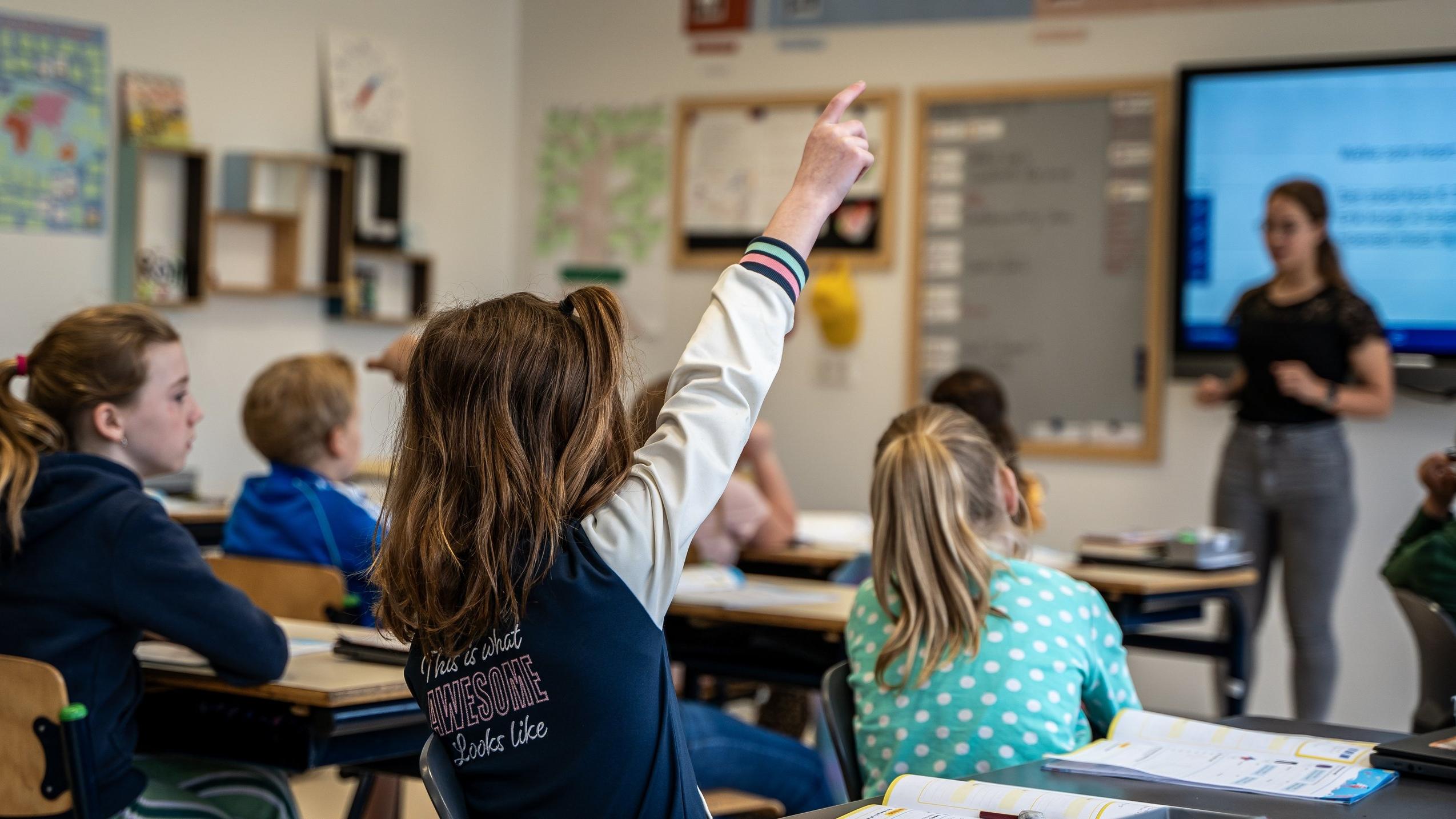 Leerlingen in de klas van Basisschool De Regenboog in De Bilt steken hun hand op tijdens een les. Leerlingen in de klas van Basisschool De Regenboog in De Bilt steken hun hand op tijdens een les.