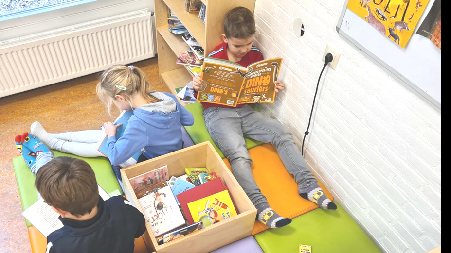 Leerlingen lezen boeken op de comfortabele banken in de Plaswijckschool in Gouda.