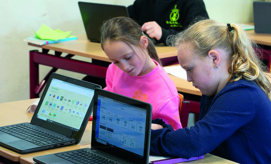 Leerlingen van Christelijk Kindcentrum De Wiedewereld in Sint Jansklooster werken samen aan hun laptops in de klas. Leerlingen van Christelijk Kindcentrum De Wiedewereld in Sint Jansklooster werken samen aan hun laptops in de klas.