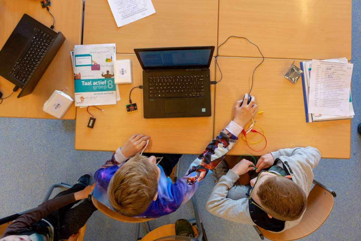 Leerlingen van de Antoniusschool in Kudelstaart werken samen aan een taaloefening met laptops en lesmateriaal. Leerlingen van de Antoniusschool in Kudelstaart werken samen aan een taaloefening met laptops en lesmateriaal.