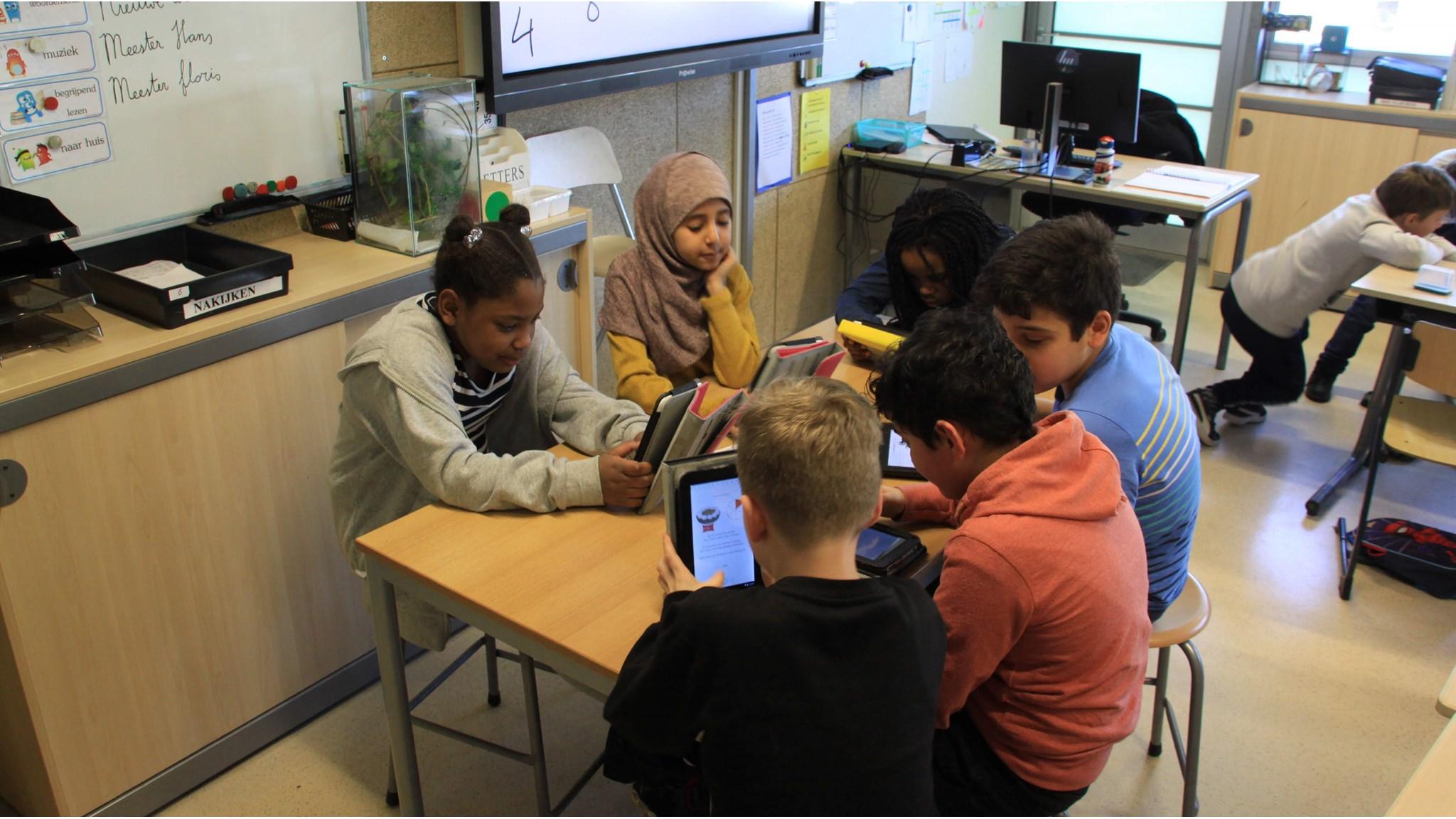 Leerlingen van IKC Eestroom in Leeuwarden werken samen aan digitale apparaten in de klas. Leerlingen van IKC Eestroom in Leeuwarden werken samen aan digitale apparaten in de klas.