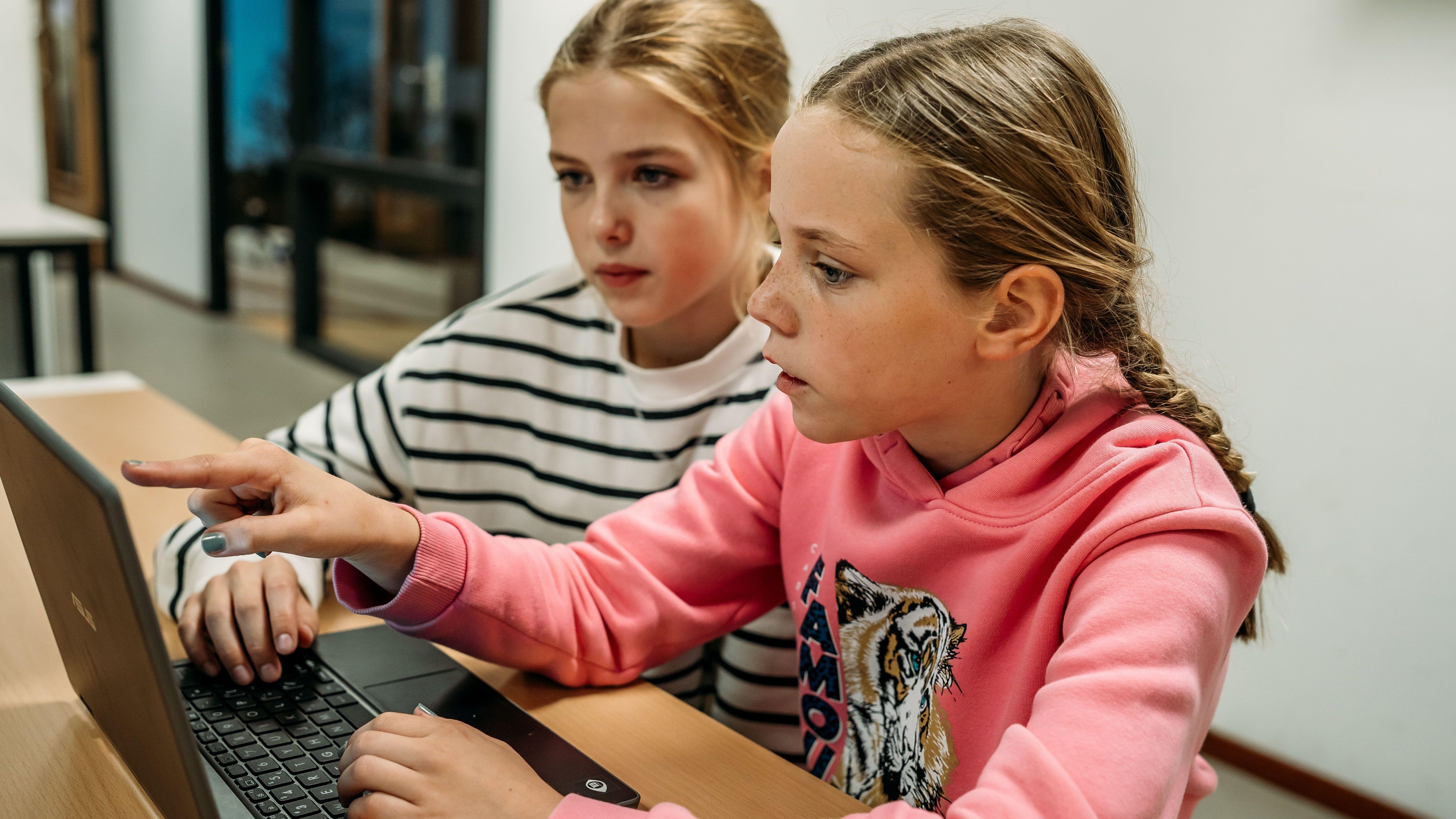 Leerlingen van KC Het IJzeren Kind in Rosmalen werken samen aan een laptop.