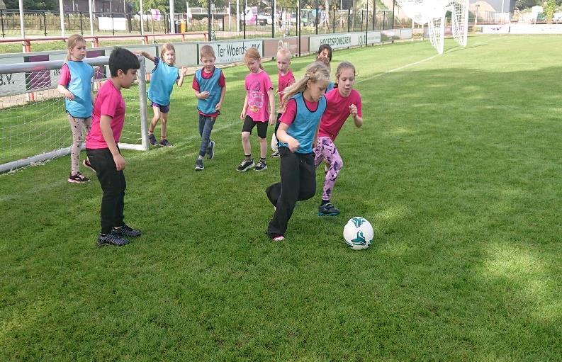 Leerlingen van Openbare Basisschool Kiezel en Kei in Borculo spelen voetbal op het schoolplein. Leerlingen van Openbare Basisschool Kiezel en Kei in Borculo spelen voetbal op het schoolplein.