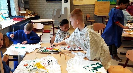 Leerlingen van SBO de Windroos, locatie de Goffert in Nijmegen, zijn bezig met schilderen op T-shirts tijdens een creatieve activiteit. Leerlingen van SBO de Windroos, locatie de Goffert in Nijmegen, zijn bezig met schilderen op T-shirts tijdens een creatieve activiteit.