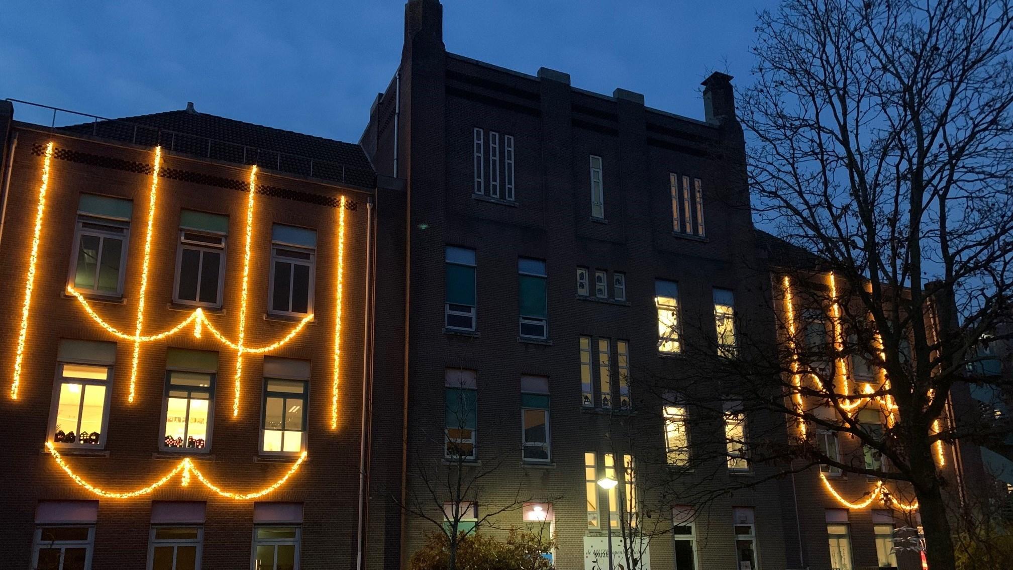 OBS De Muze in Nijmegen, verlicht met sfeervolle kerstversiering aan de gevel. OBS De Muze in Nijmegen, verlicht met sfeervolle kerstversiering aan de gevel.