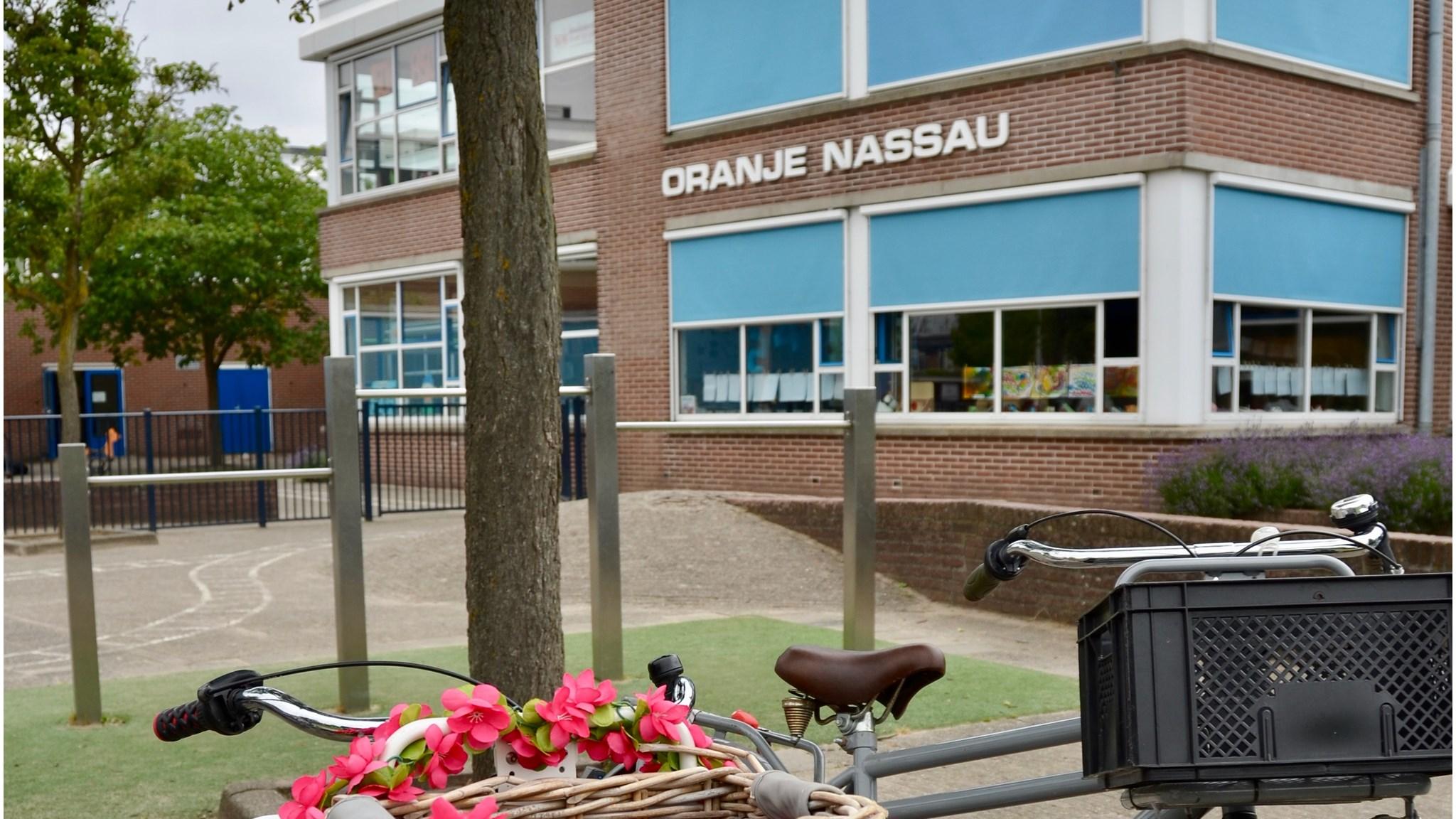 Oranje Nassauschool in Dordrecht met een fiets en bloementslinger op het schoolplein. Oranje Nassauschool in Dordrecht met een fiets en bloementslinger op het schoolplein.