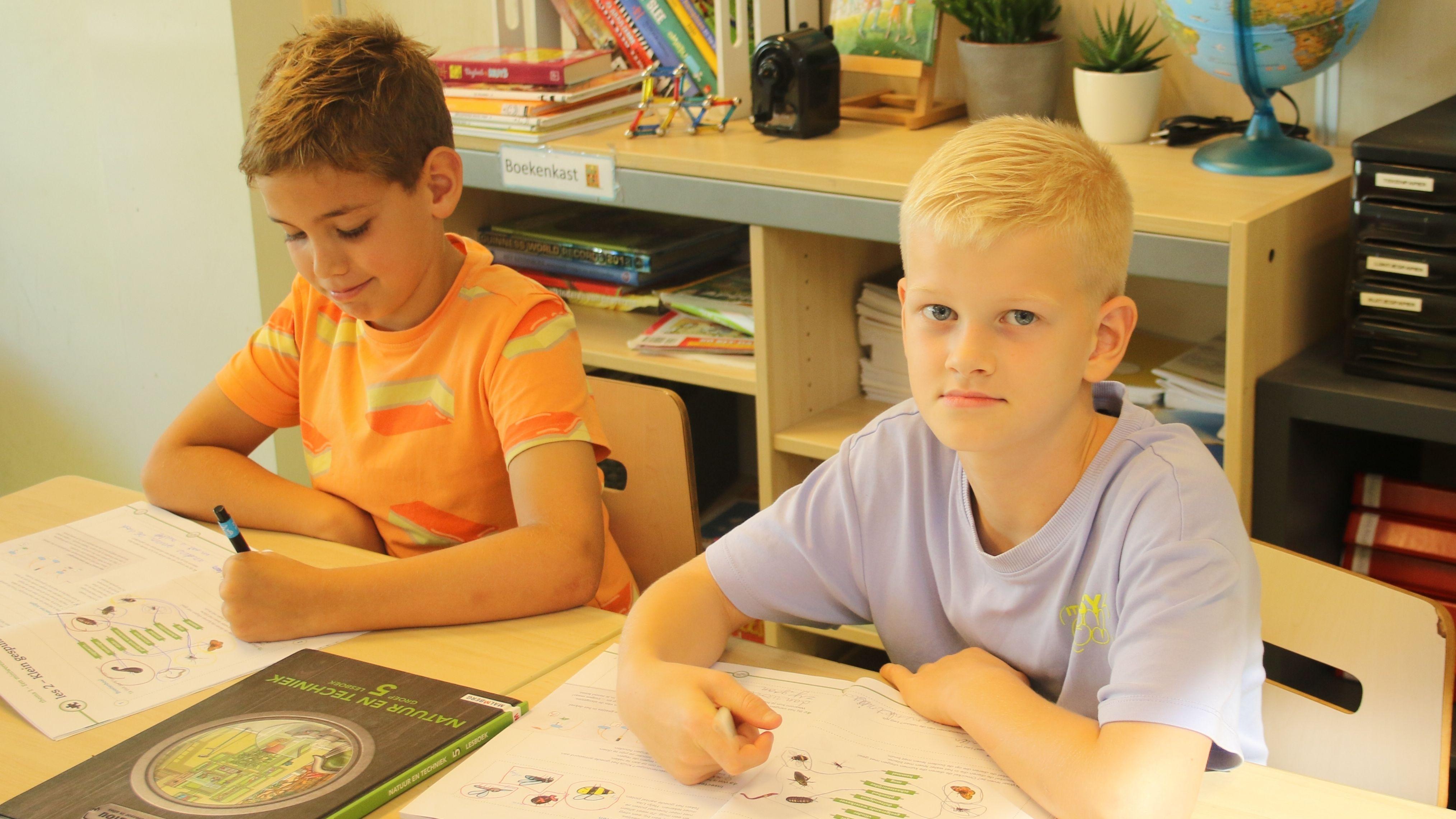 Twee jongens aan een tafel in IKC Prins Claus in Zoetermeer, terwijl ze werken aan hun schoolopdrachten. Twee jongens aan een tafel in IKC Prins Claus in Zoetermeer, terwijl ze werken aan hun schoolopdrachten.