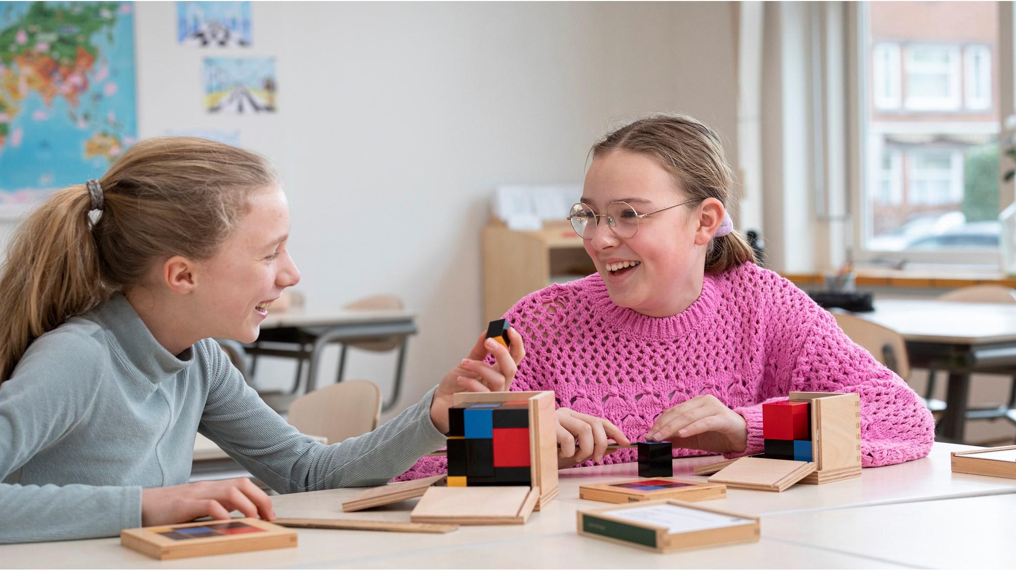 Twee leerlingen aan de Jacob Maris school in Rotterdam spelen samen met kleurige bouwblokken. Twee leerlingen aan de Jacob Maris school in Rotterdam spelen samen met kleurige bouwblokken.